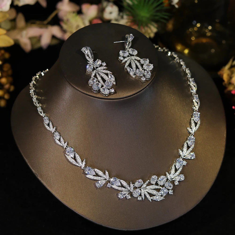 Side-angle view of a luxury CZ choker necklace and matching statement earrings highlighting the brilliant leaf cluster pattern.