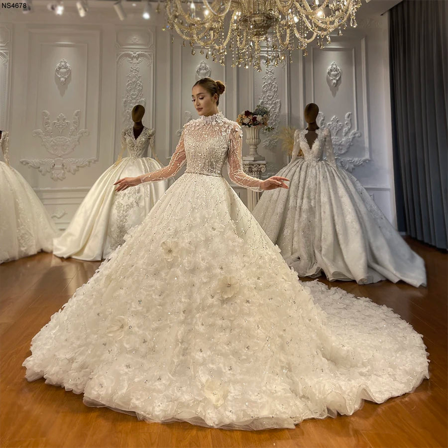 Full-length view of an elegant A-line wedding dress featuring a high-neck long-sleeve beaded jacket and a voluminous 3D floral skirt.