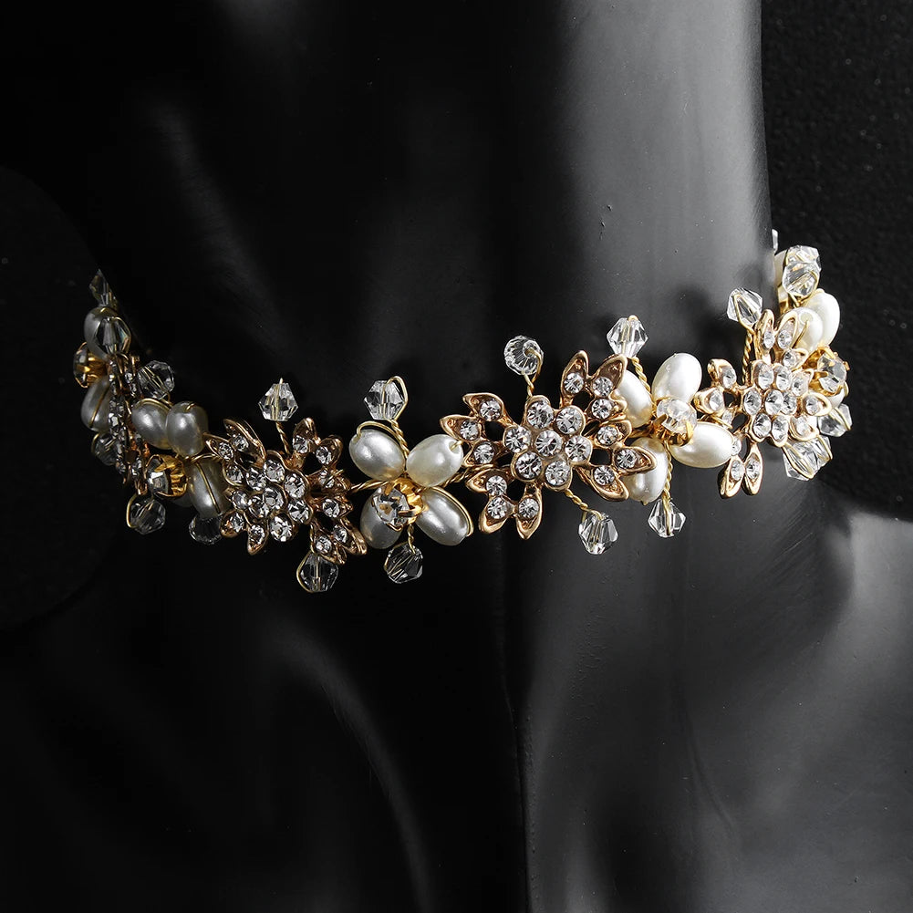 A detailed shot of an elegant pearl flower bridal tiara styled as a necklace or hair accessory.