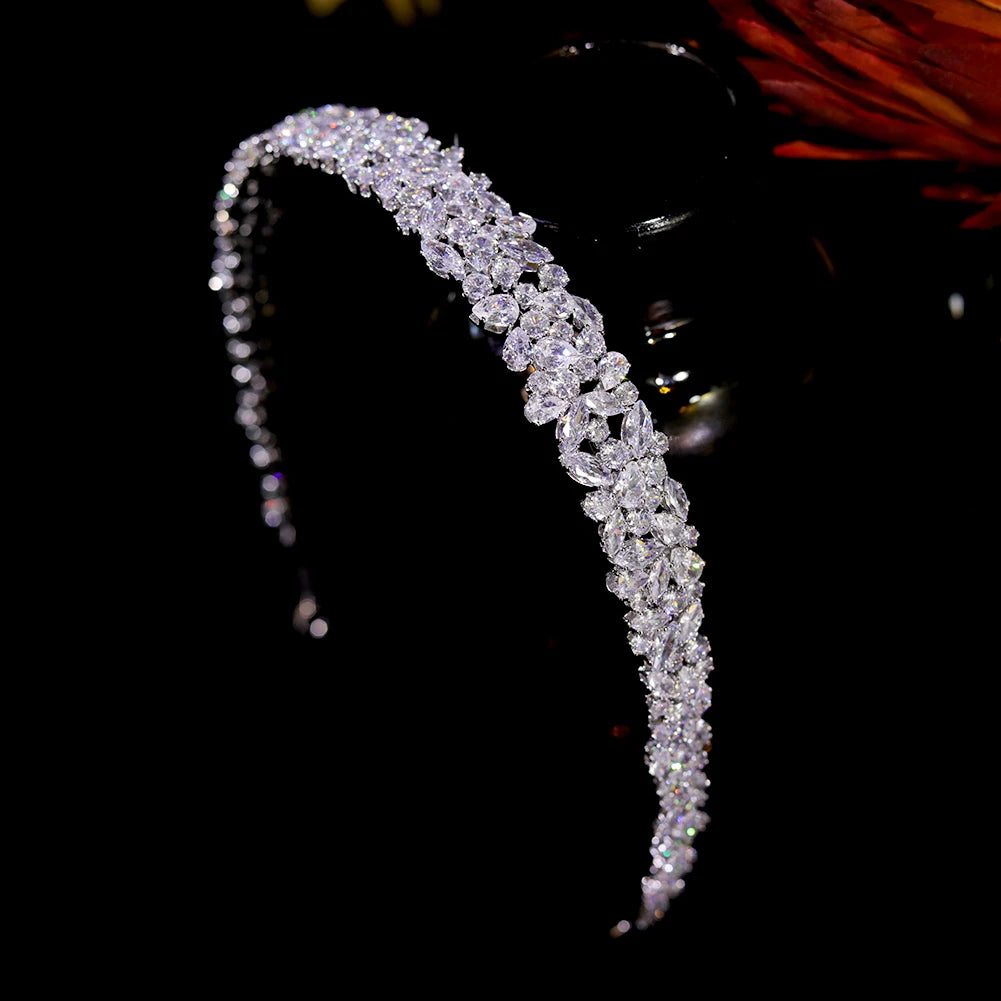 Alternate side perspective of the sparkling rhinestone bridal tiara band, highlighting its multi-layered crystal setting on a black background.
