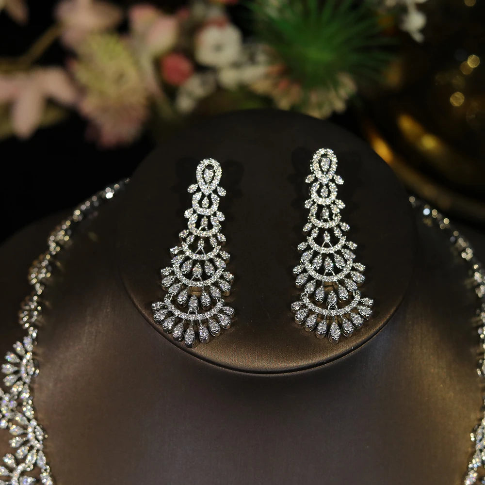 Macro view of elegant cubic zirconia chandelier drop earrings from a luxury bridal jewelry set.