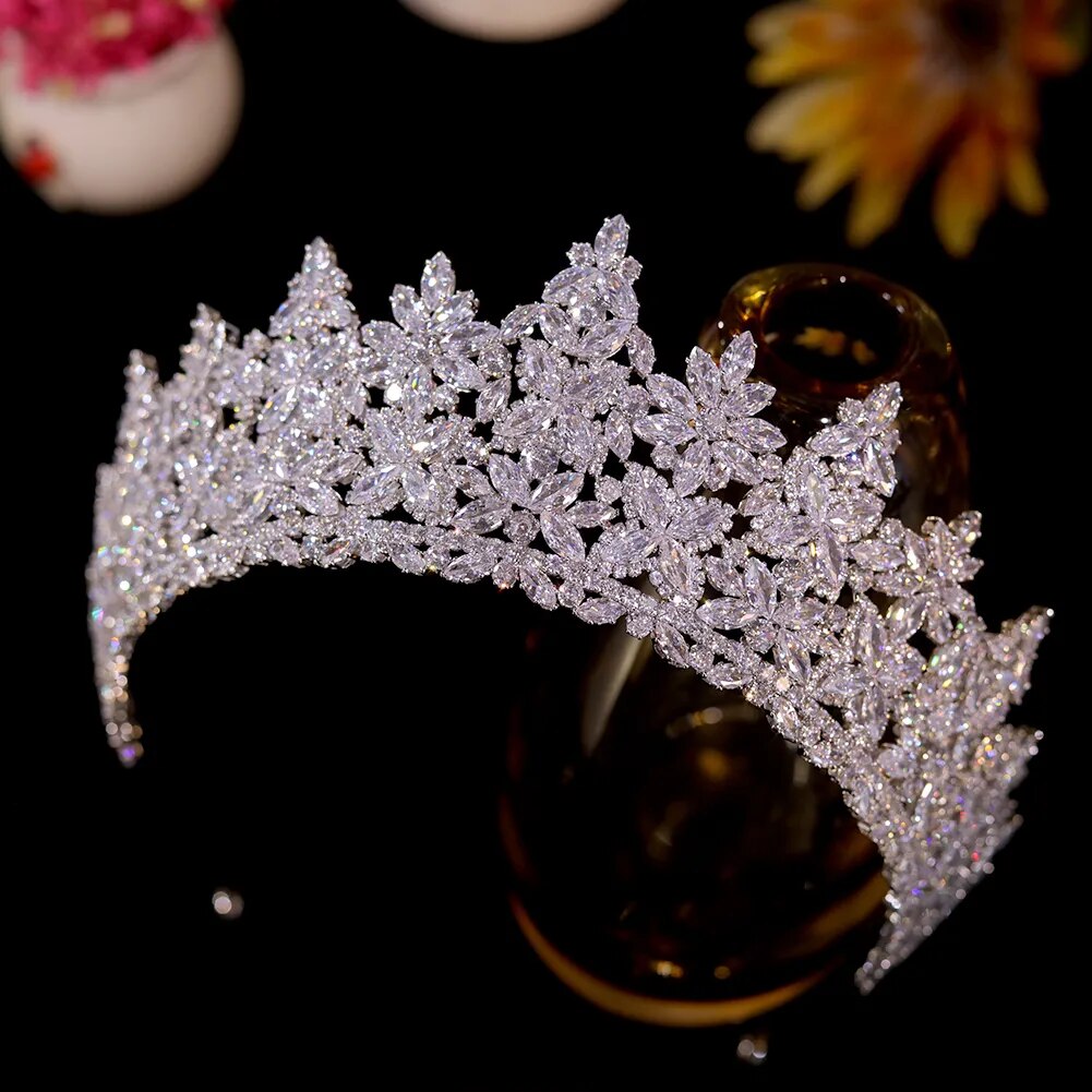 Close-up angled product photograph focusing on the fine micro-pave stone settings and detailed flower cluster arches of a premium silver wedding crown.
