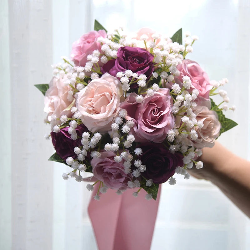 Elegant multi-shaded purple and mauve silk rose wedding bouquet accented with small white flowers for bridesmaids.