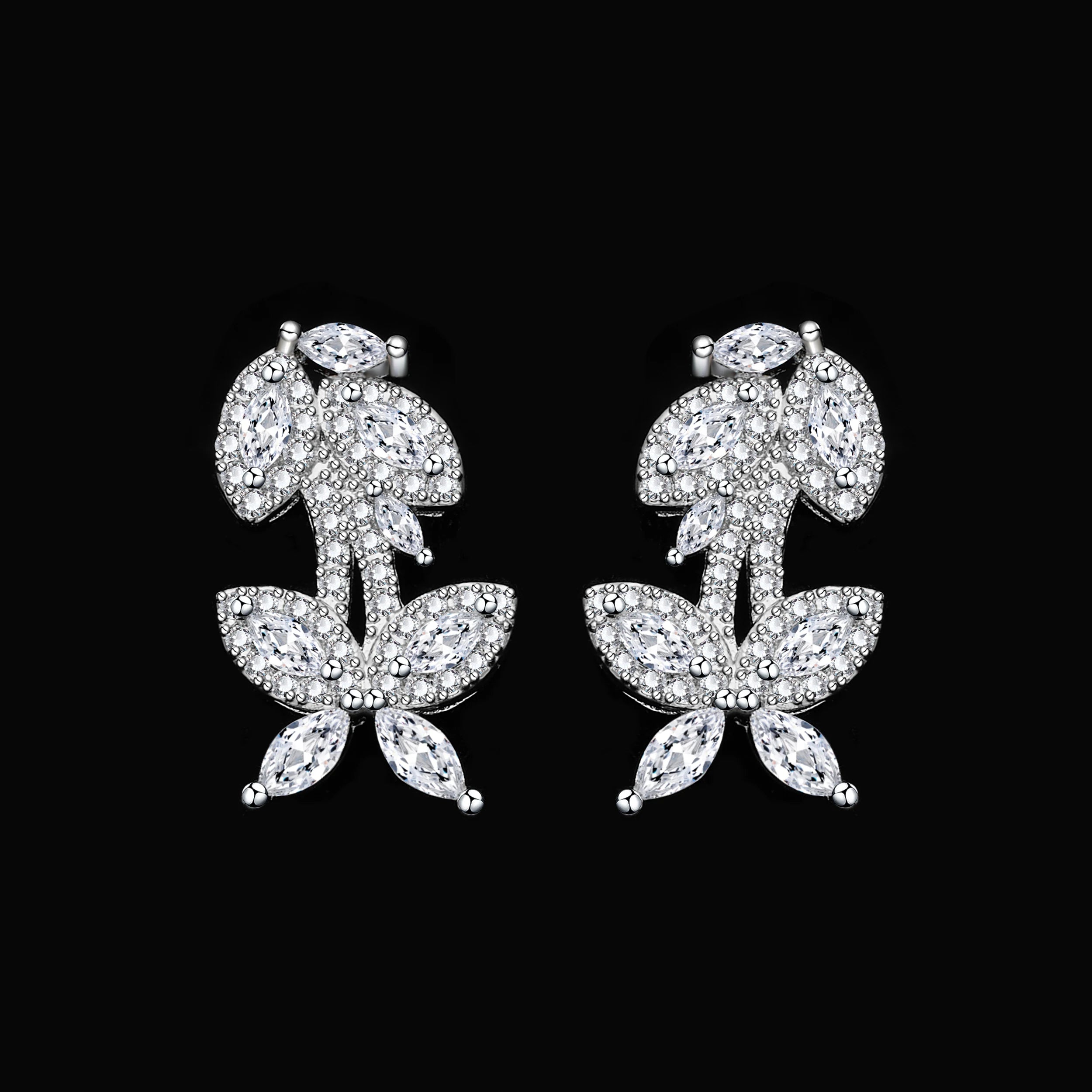 Close-up macro view of the matching cubic zirconia branch-design wedding earrings on a solid black background.