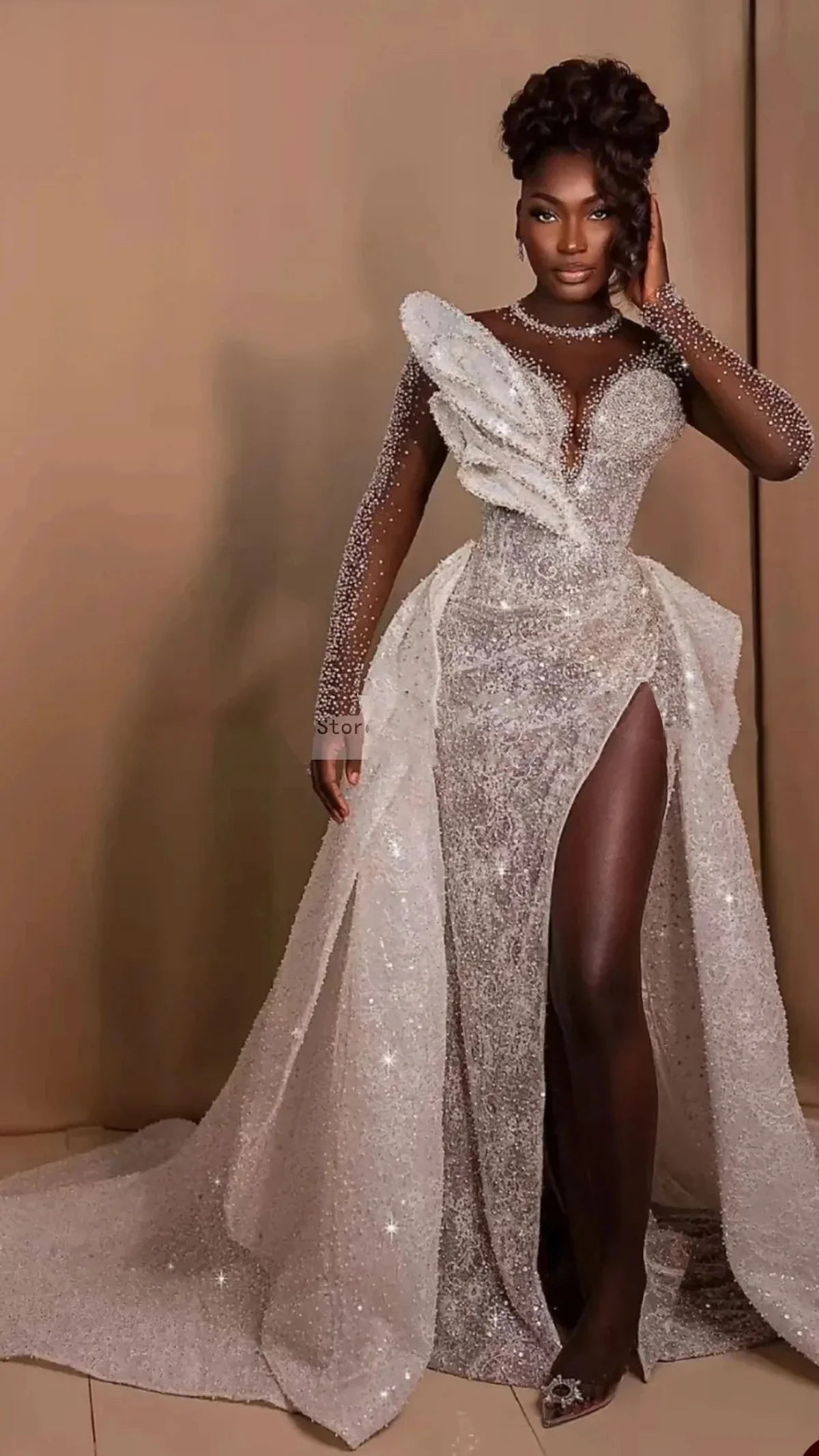 2-in-1 plus size sheer net mermaid bridal gown outfitted with its dramatic open-front crystal overskirt train, styled beautifully for an opulent evening reception.