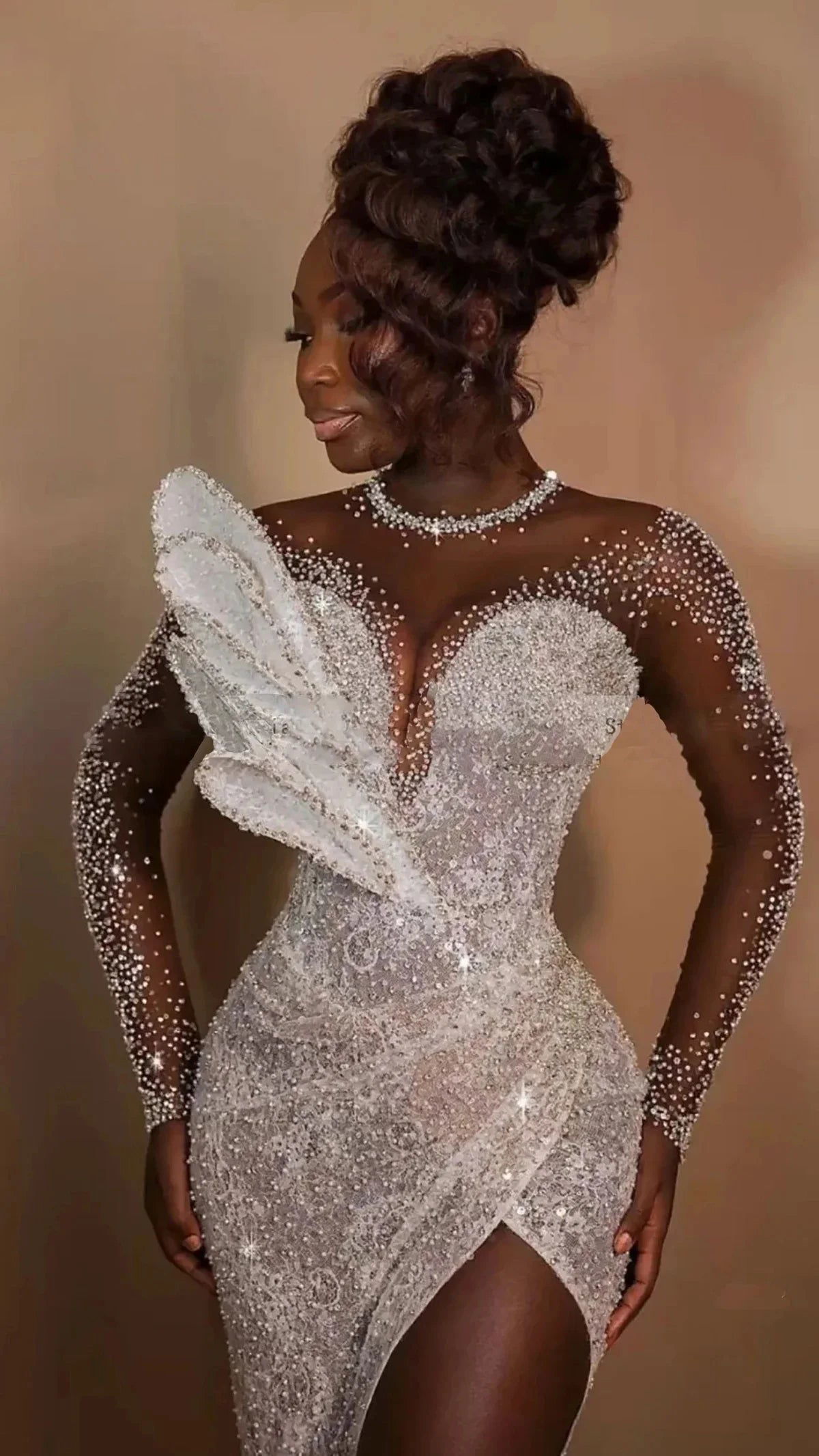 Detailed close-up of a luxury wedding dress bodice emphasizing the sheer illusion neck mesh, thousands of hand-placed micro-crystals, and a structural white fan ruffle accent.