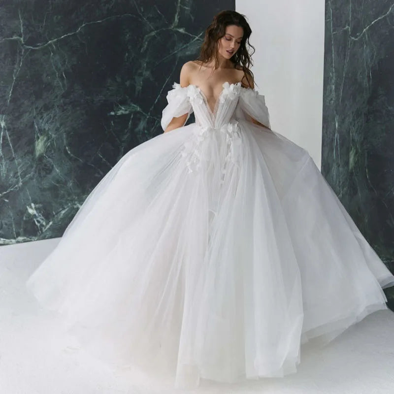 Elegant princess-style wedding dress featuring 3D flower appliques, a sweetheart neckline, and voluminous tulle skirt with detachable sleeves.