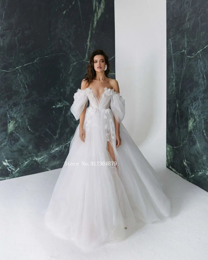 Model posing in a 3D flower bridal gown featuring an elegant sweetheart neckline and chic detachable sleeves.