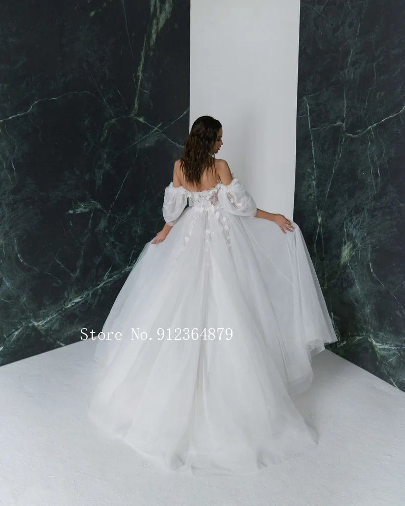 Elegant open-back wedding dress with 3D flower appliques and stylish detachable sleeves, perfect for a modern princess bridal look.