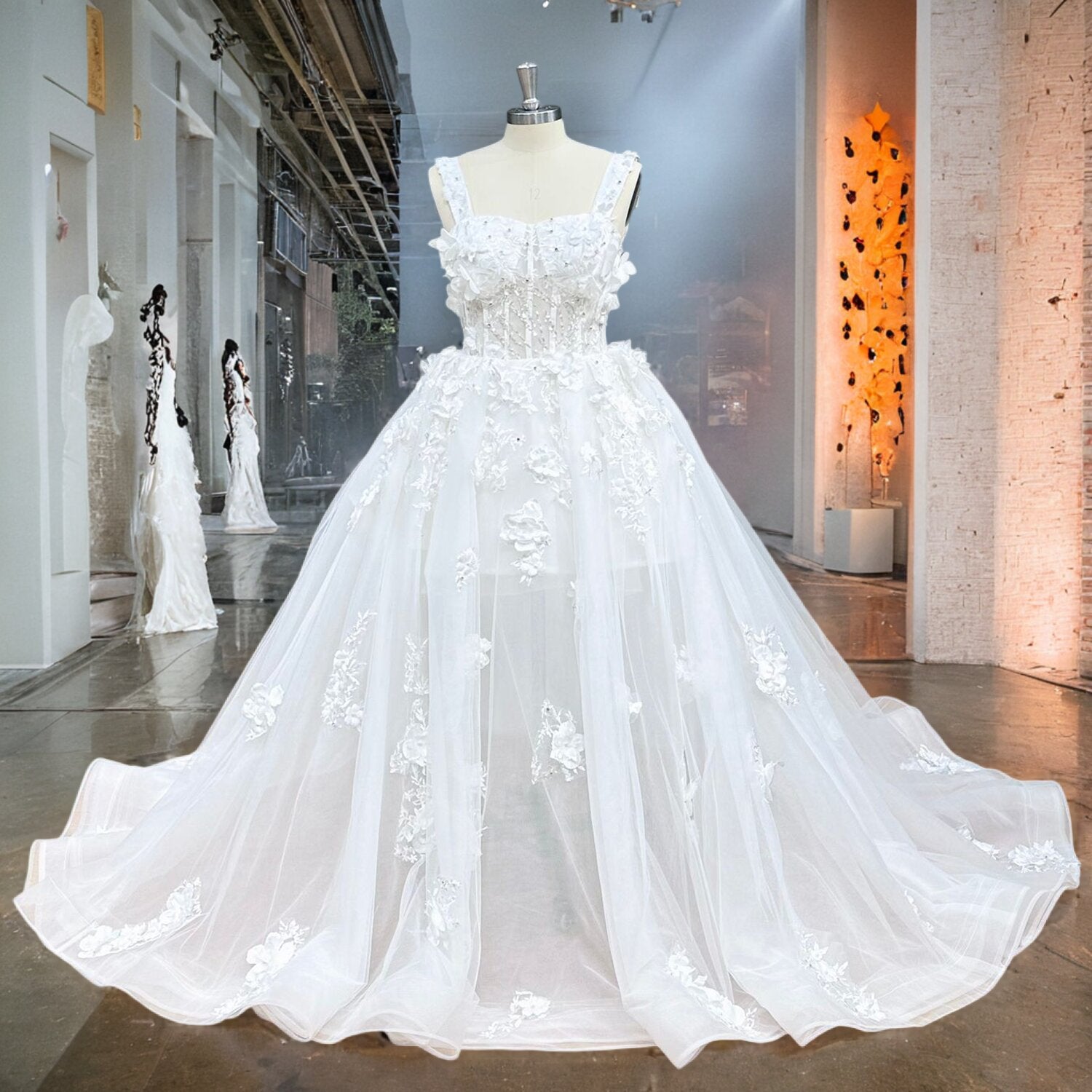 White square-neck ball gown wedding dress with a heavily beaded corset top and textured floral overlays displayed on a mannequin.