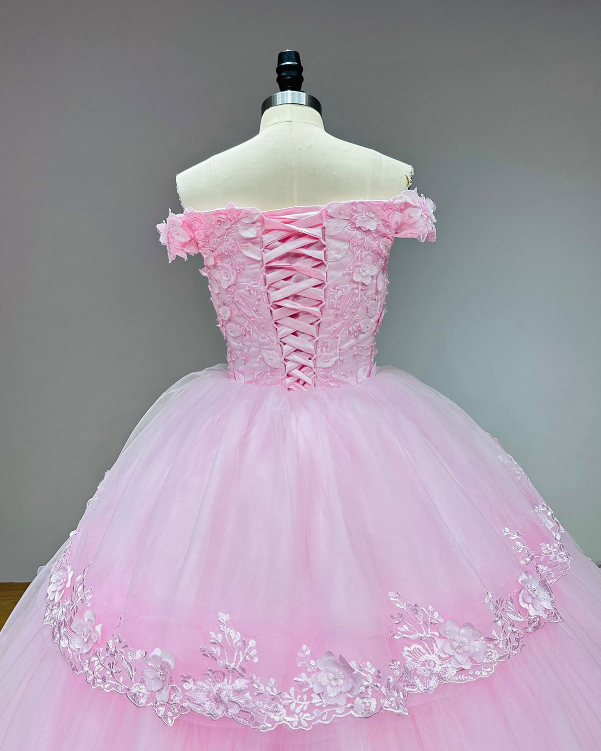 Close-up front view of the pink bridal dress bodice, showcasing the sweetheart neckline, off-the-shoulder bands, and heavy 3D floral lace embellishments.