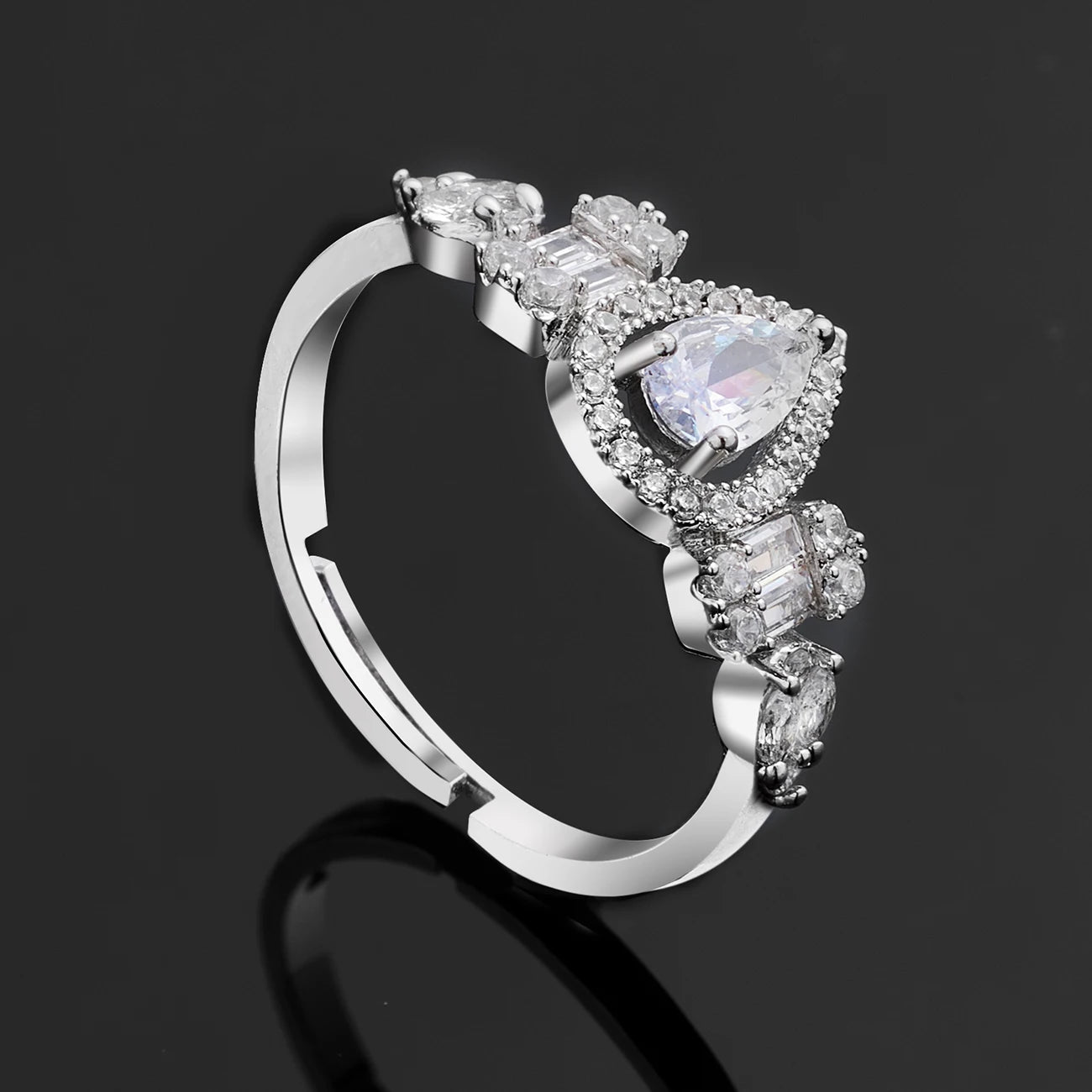 Profile view of a silver cubic zirconia wedding ring for women, showcasing a central halo teardrop crystal and channel-set accents.