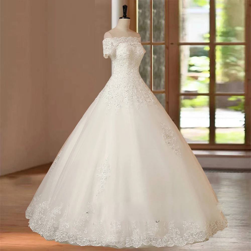 Side profile view of a luxury off-the-shoulder A-line wedding dress, displaying the graceful flow of the tulle skirt and the delicate beadwork on the bodice.