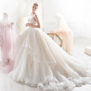 Elegant sleeveless A-line wedding dress featuring a V-neck, delicate beaded bodice, and voluminous ruffled skirt for a classic bride look.