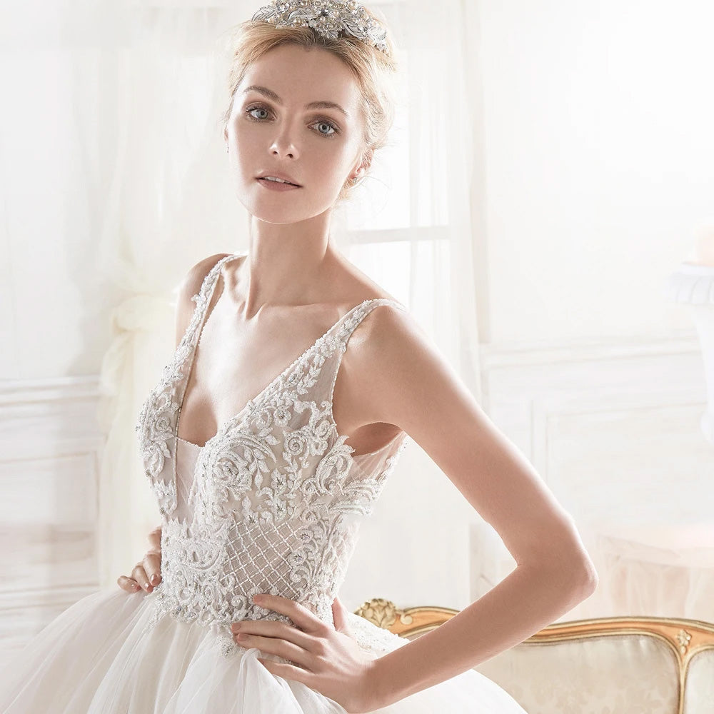 Close-up of the exquisite beaded V-neck bodice on a sleeveless A-line wedding gown, highlighting detailed bridal craftsmanship.