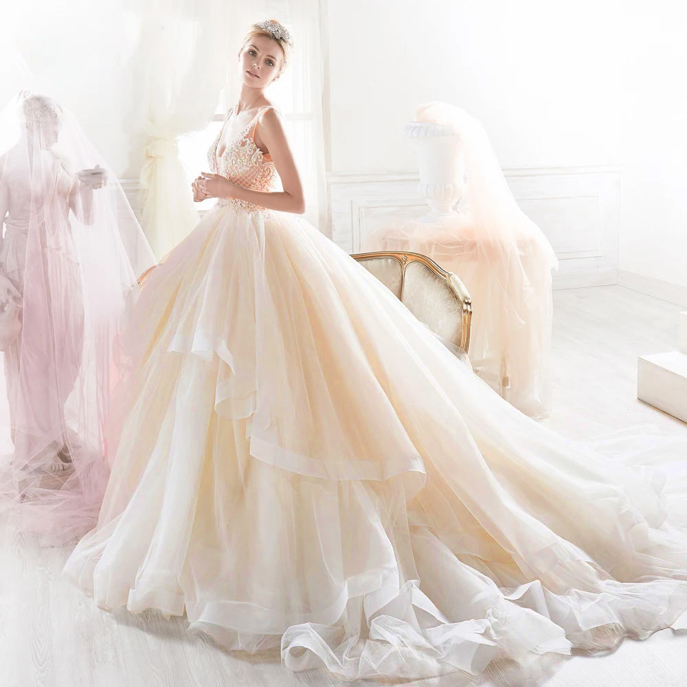 Full-length front profile of a luxurious sleeveless A-line wedding dress with a beaded bodice and layered ruffles.