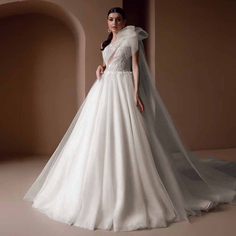 Elegant front portrait display of the beaded applique off-shoulder wedding gown, rendered in a romantic soft blush pink color variation option.