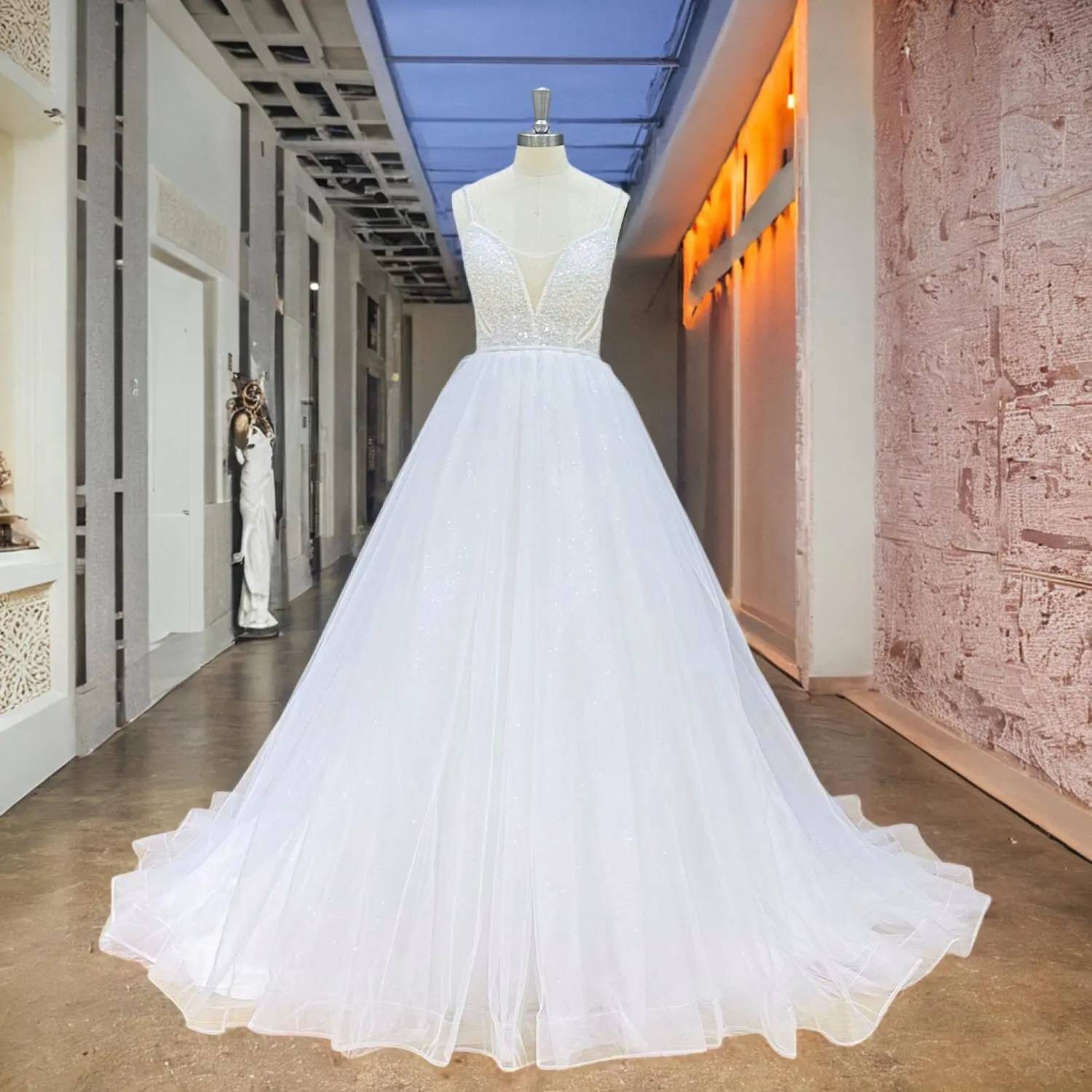 Front perspective of a sparkling A-line wedding dress with beading and pearls, featuring a voluminous layered tulle skirt and a structured sweetheart bodice displayed in a luxury bridal boutique.
