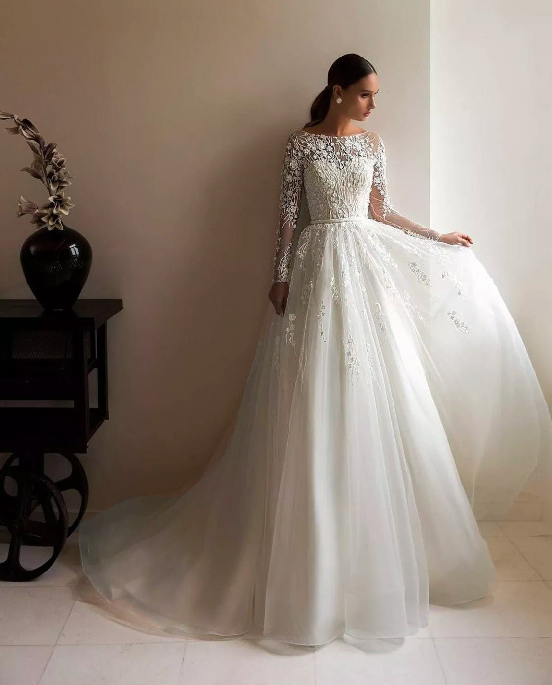 Close-up of the delicate lace sleeve detail on a champagne tulle A-line wedding dress.