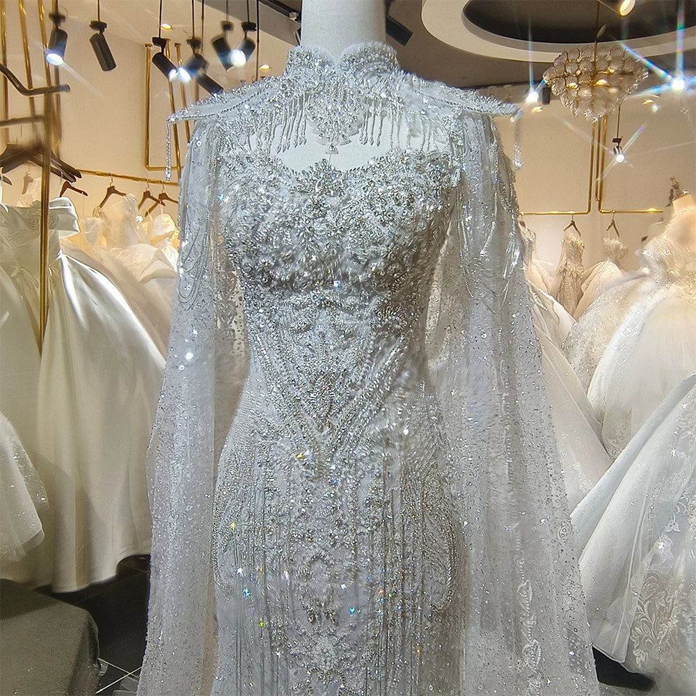 Close-up view of the wedding dress back closure, highlighting the classic bridal buttons aligned perfectly along the sheer illusion lace mesh.