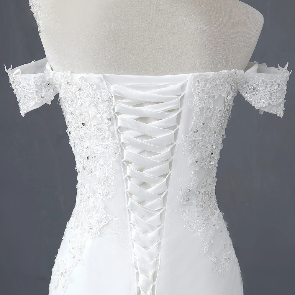 Detailed rear view of the mermaid wedding dress focusing on the corset-style lace-up back and refined lace embellishments.