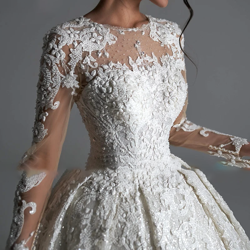Close-up view of the luxury beaded lace bodice and long sleeves of the AmyLvager classic ball gown, highlighting the fine craftsmanship.