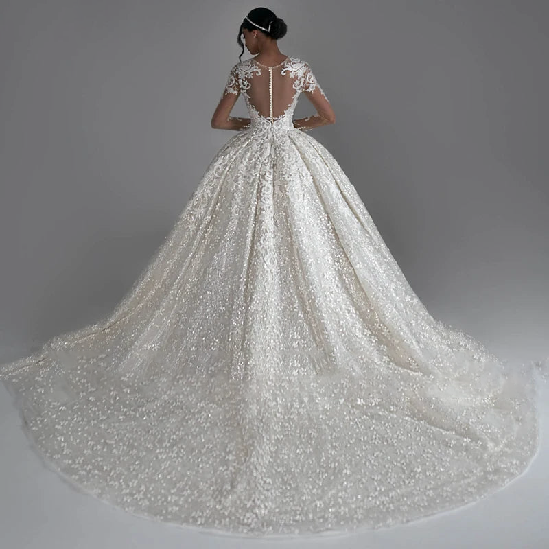 Stunning back profile of the classic ball gown, emphasizing the intricate lace patterns and the expansive court train.