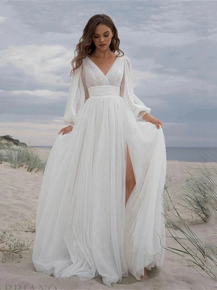 Beautiful BOHO vintage-style wedding dress with a V-neck and a daring thigh-high slit, highlighting the ethereal tulle fabric.