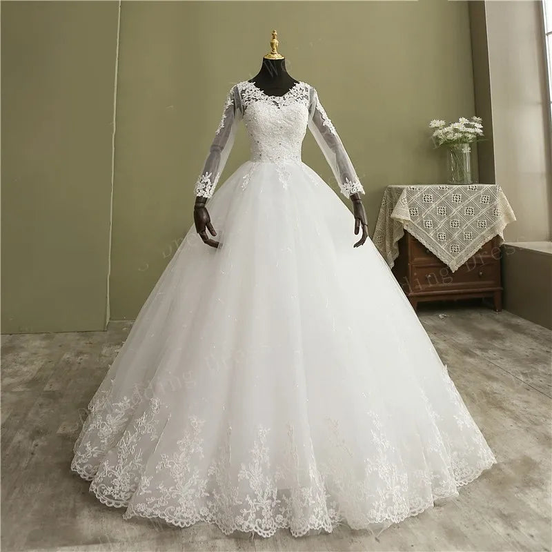 High-resolution studio portrait of the long sleeve V-neck lace ball gown wedding dress, highlighting the royal structured flare and continuous floral lace appliques.