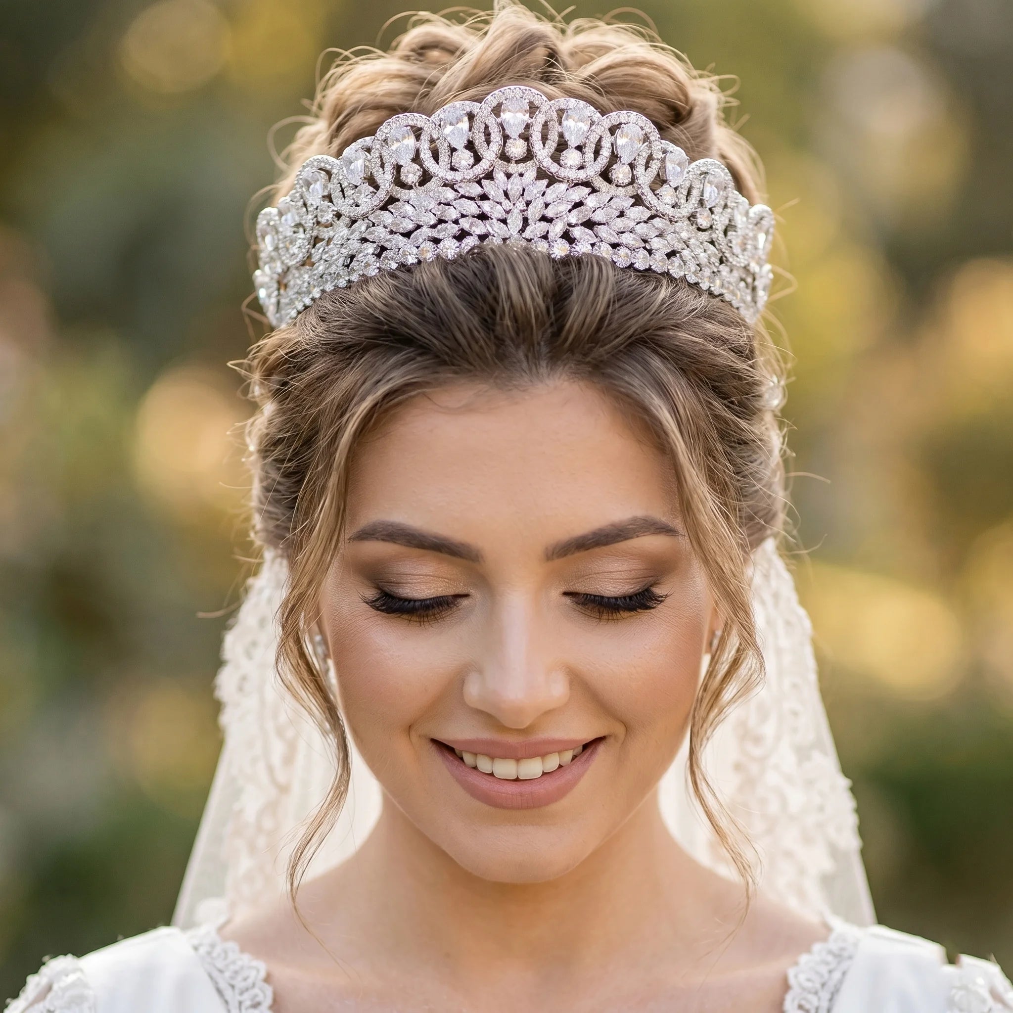 Close-up portrait of a bride wearing a luxury baroque crystal zircon bridal crown with an elegant updo hairstyle