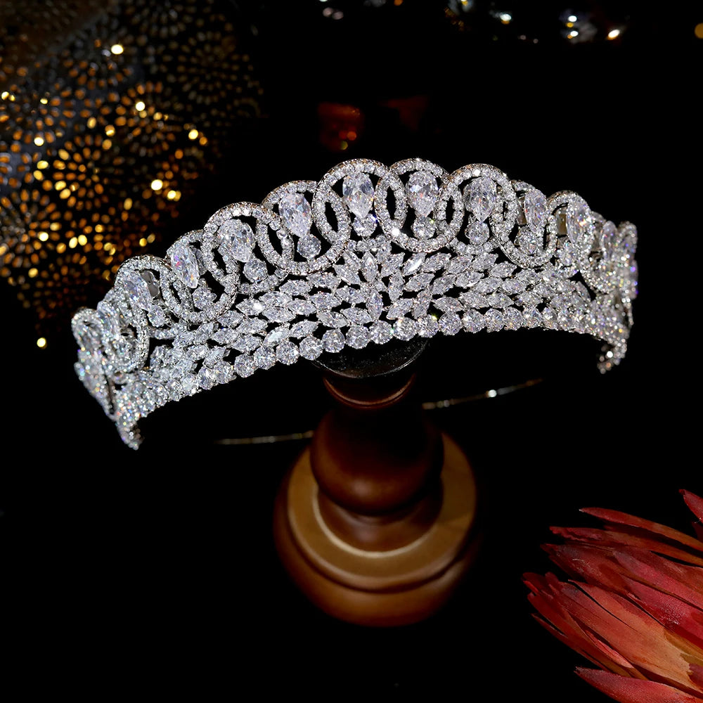 Luxury zircon bridal crown for pageants and weddings presented on a classic wooden jewelry pedestal