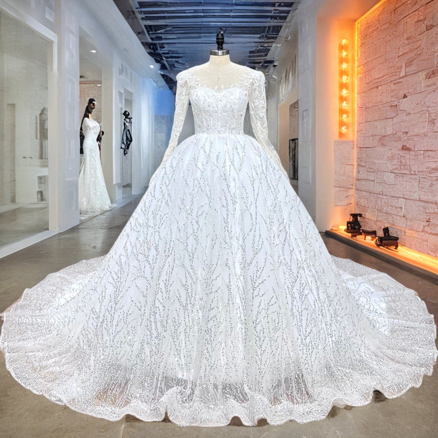Shimmering long sleeve beaded ball gown wedding dress with a glitter branch pattern displayed on a mannequin in an upscale showroom.