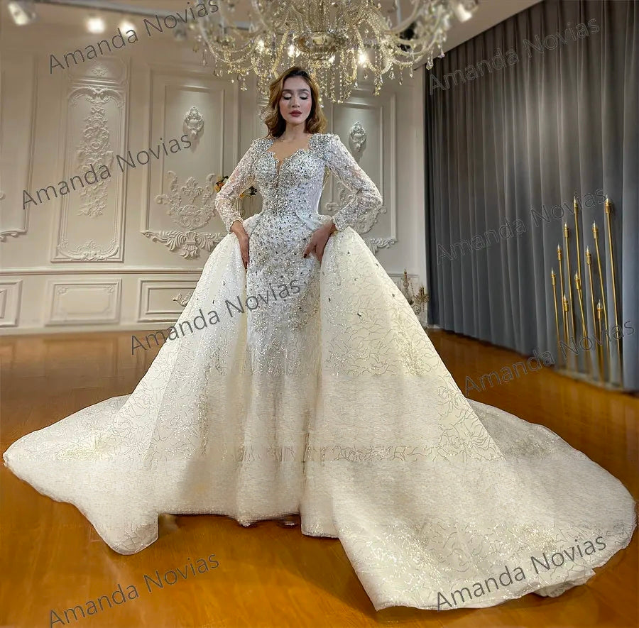 Sophisticated ivory mermaid wedding dress highlighting the dramatic scale of the shimmering detachable train and intricate lace appliques.