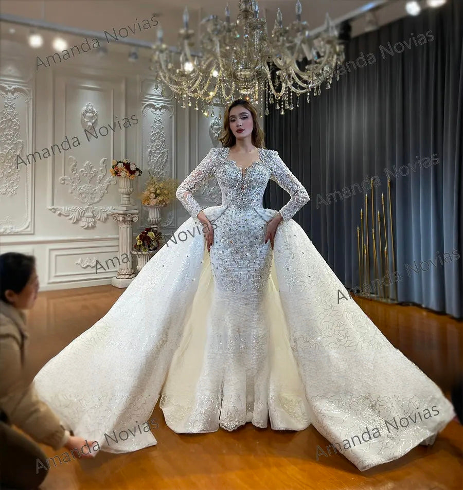A regal 2-in-1 wedding dress featuring a mermaid base transformed into a voluminous ball gown with a massive detachable overskirt and cathedral-length train.