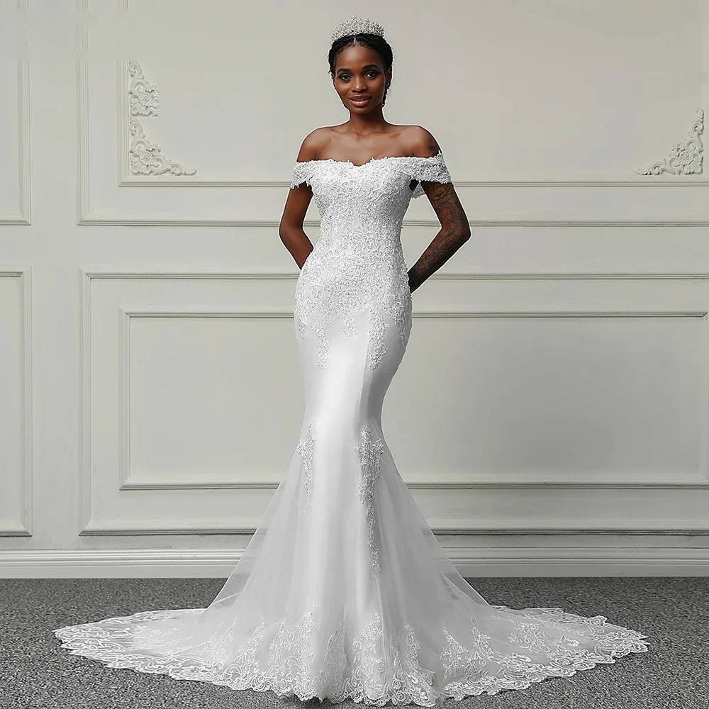 Full-length front view of an off-shoulder mermaid wedding dress with intricate hand-beaded lace appliqué and a sweeping train.