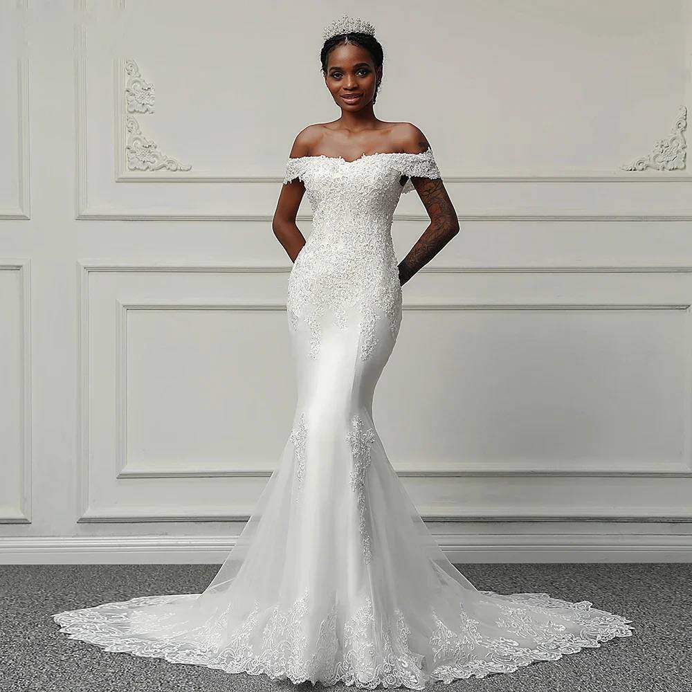 Front profile of an off-shoulder mermaid wedding dress with hand-beaded floral appliqué and a structured lace bodice.