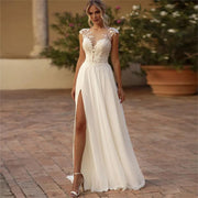 Boho lace A-line chiffon wedding dress with a high leg slit, cap sleeves, and a deep illusion V-neckline.