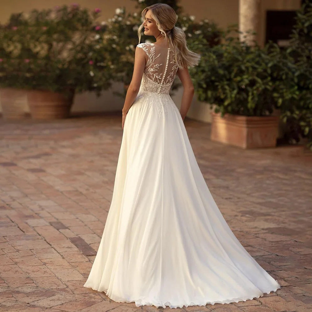 Back view of a boho-style A-line wedding dress featuring an illusion lace back with button-down detailing.