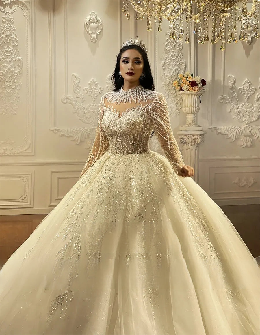 Front perspective of a shimmering ball gown wedding dress highlighting the dense, handcrafted beadwork and embroidery on the bodice and high-neckline silhouette.