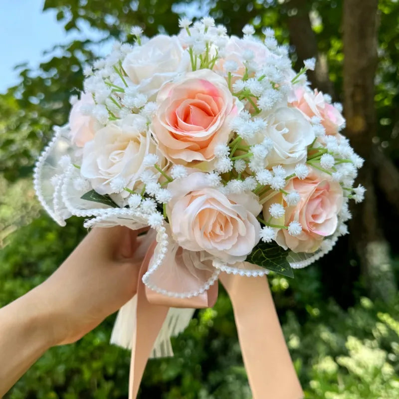 Side profile of a handmade peach silk rose bridal bouquet, detailed with a pearl lace collar and matching peach satin ribbons