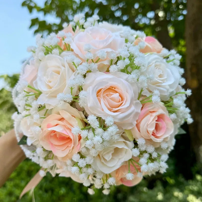 Macro photograph showcasing the realistic petals of blush pink and ivory faux roses in a handcrafted bridesmaid wedding bouquet.