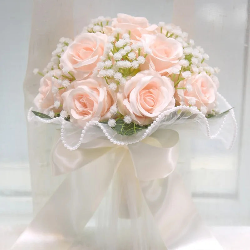 Elegant front display of a handmade soft peach silk rose bridal bouquet decorated with sheer white tulle and pearl border trim.