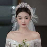 Beautiful bride wearing an elegant crystal and pearl wedding tiara with bridal veil