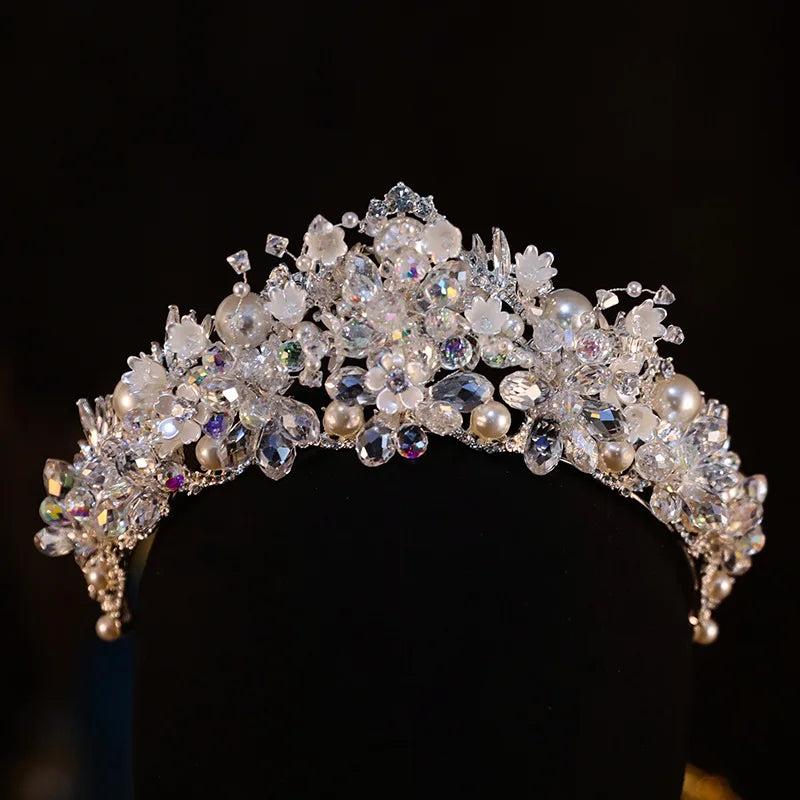 Luxury floral-inspired crystal pearl bridal crown on a black mannequin display