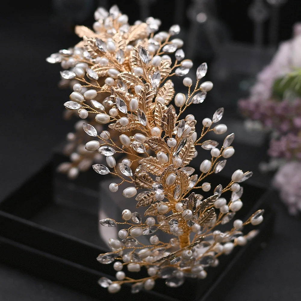 Close-up perspective of a premium gold wedding flower headband featuring dense rows of white pearls, gold-plated leaves, and clear zircon crystals.
