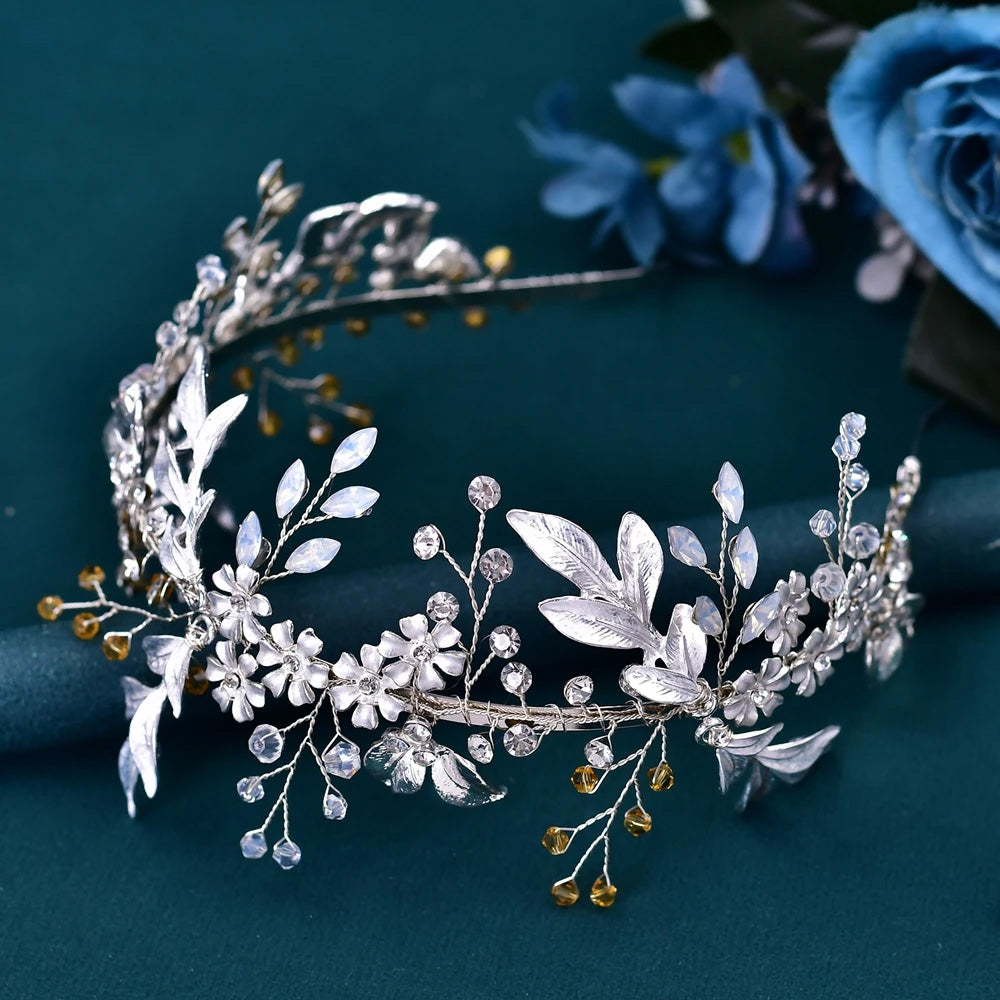 Full view of a handcrafted silver wedding headpiece headband adorned with frosted white flowers, metallic leaves, and amber bead accents.