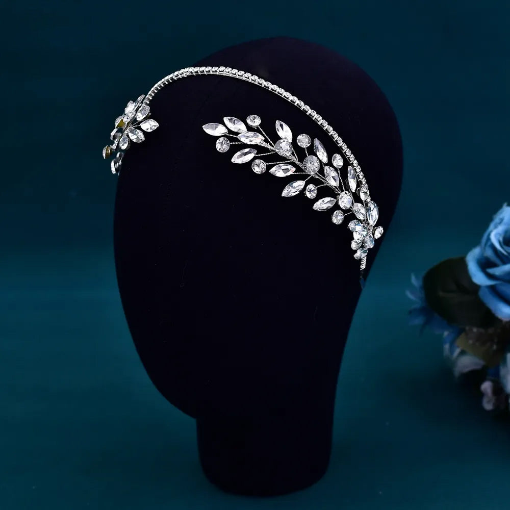 High-angle shot of a flexible silver crystal bridal hair vine and headband accent highlighting the delicate botanical branch design.