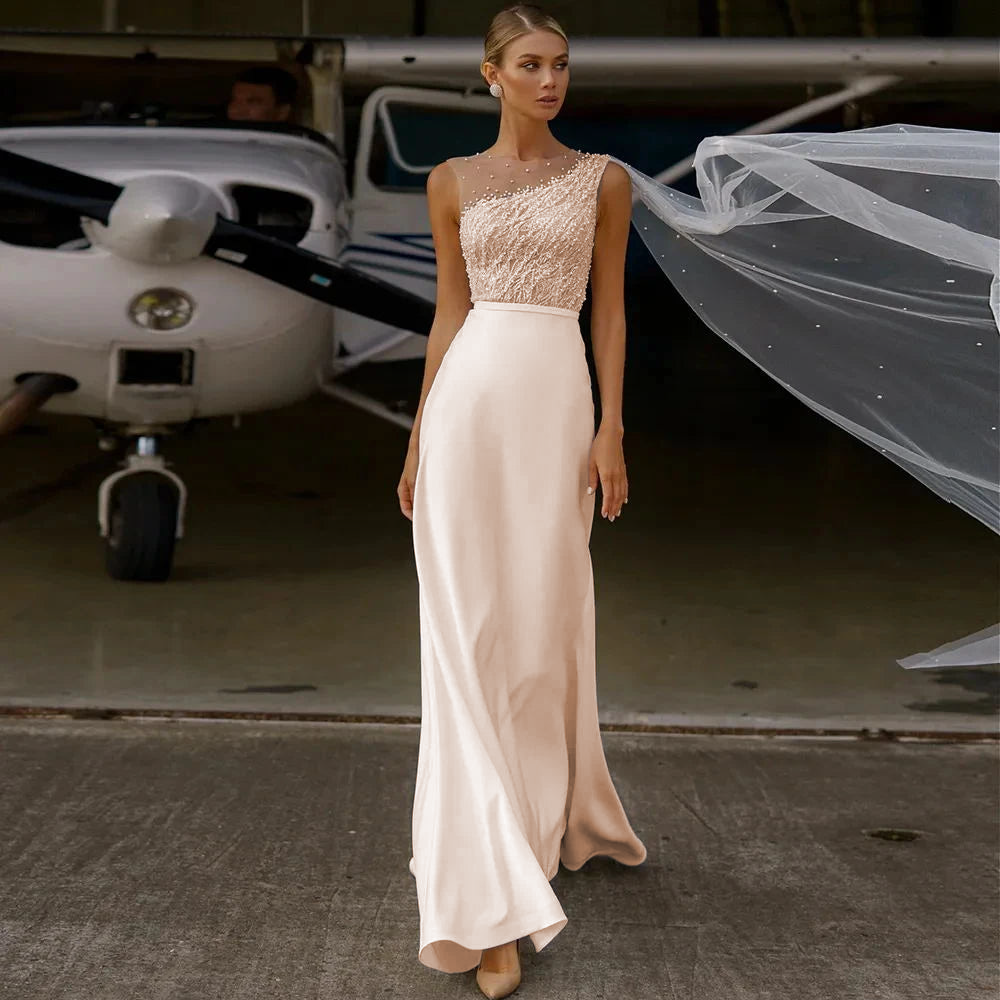 A radiant bride posing in a sleeveless beaded lace bodice wedding dress with a clean, modern A-line silhouette.
