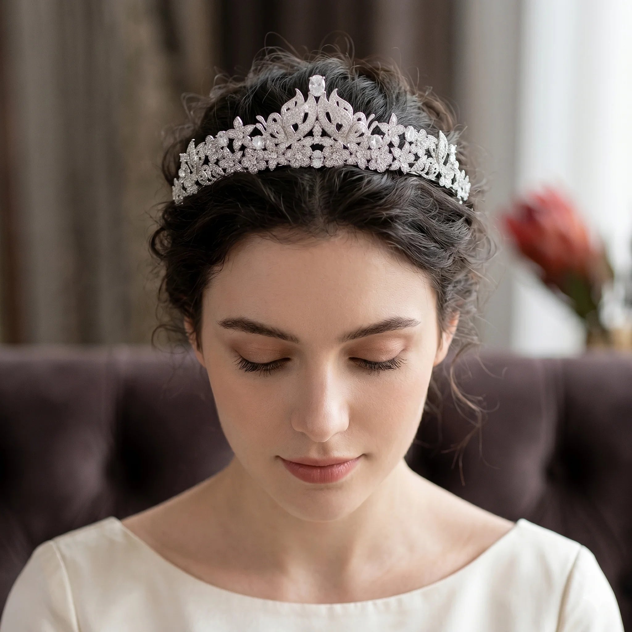 Model wearing a luxury butterfly princess bridal crown with a classic wedding updo hairstyle.