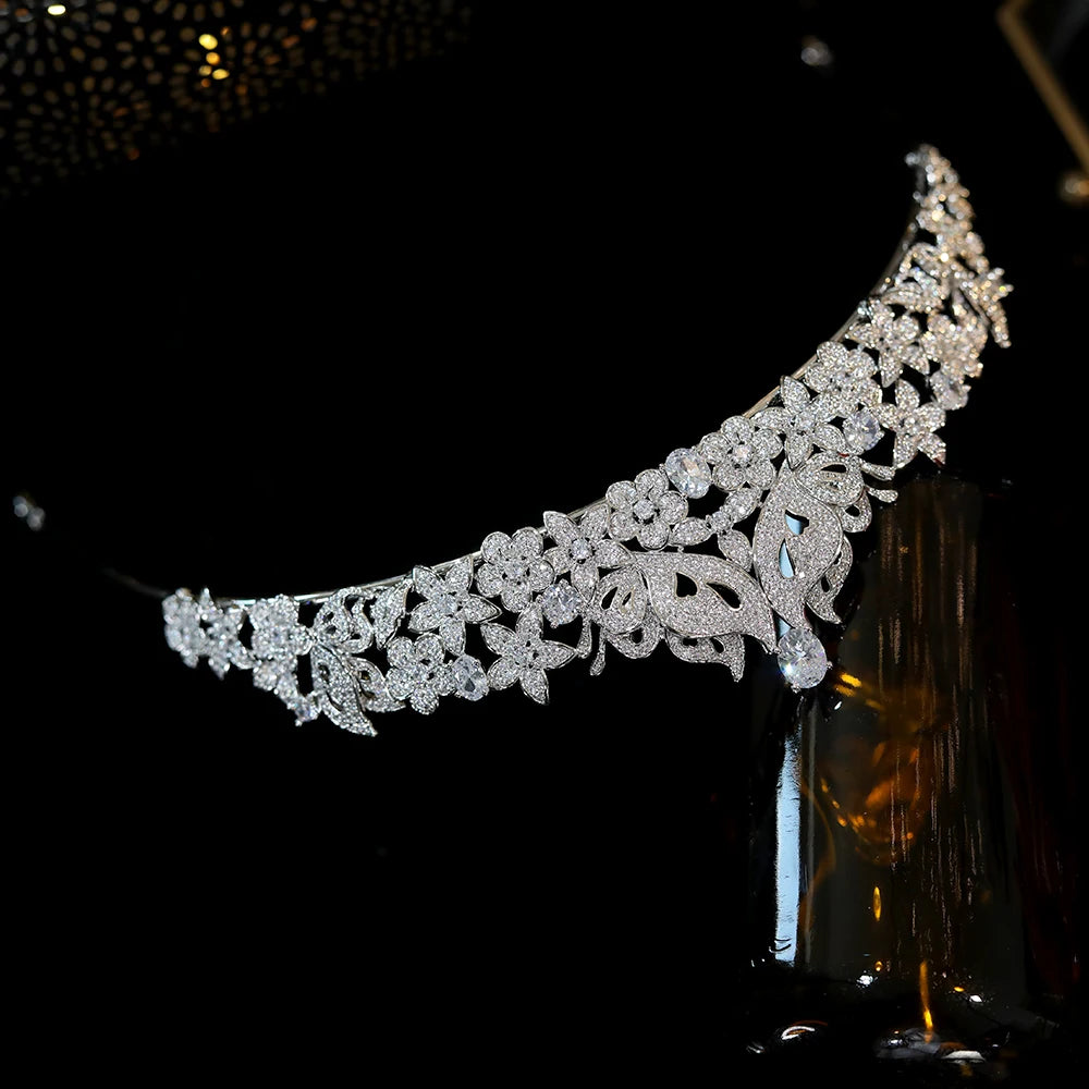 Side-angle perspective of a glittering rhinestone butterfly wedding crown hair accessory on a dark background.